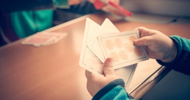 A kid playing cards