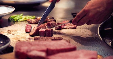 A man cutting beef pieces
