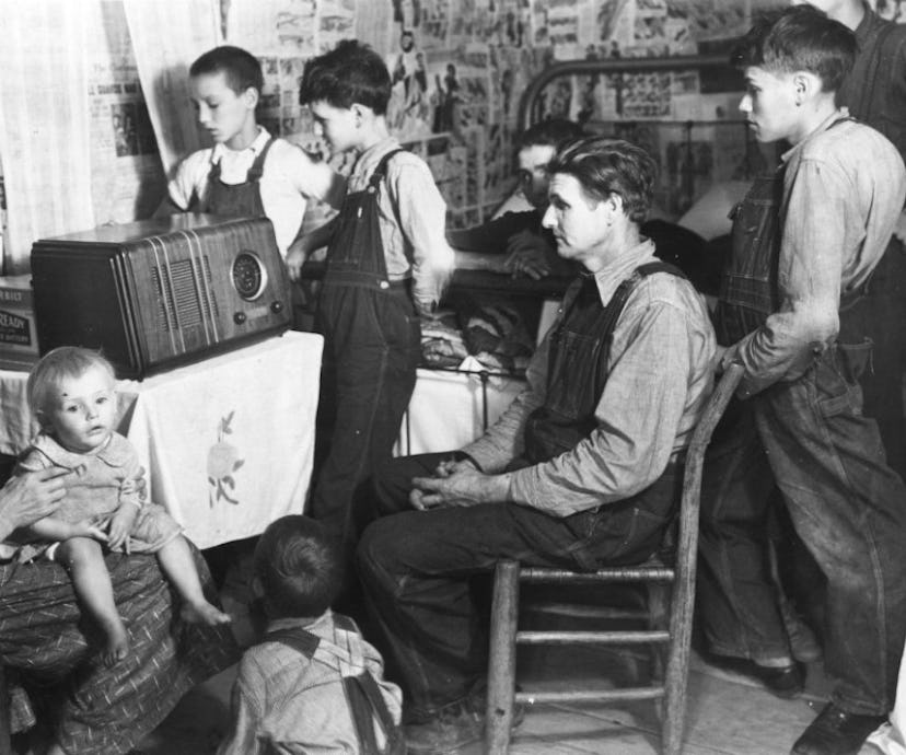 A family of seven sat around a radio listening to the daily news
