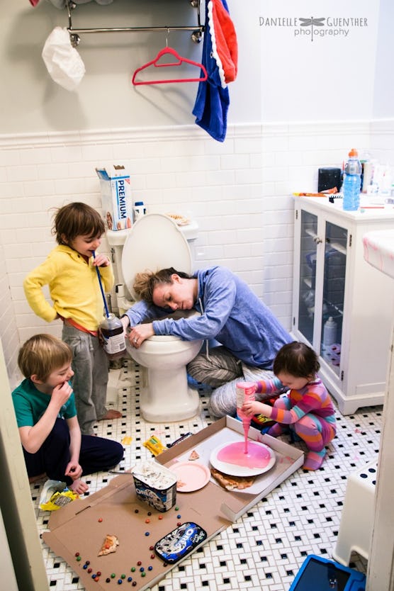 woman resting on toilet seat kids with food mess everywhere