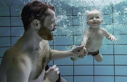 dad swimming with baby