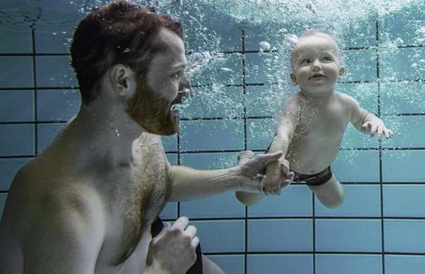 dad swimming with baby