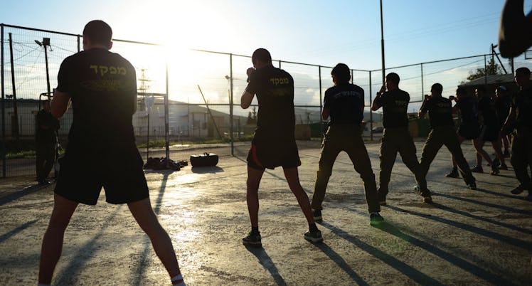 A group of people training Krav Maga during the day