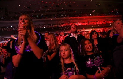A mom and her two daughters at a Justin Bieber concert