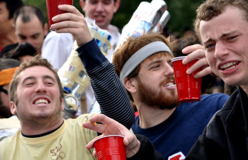 A bunch of guys enjoying and drinking from red cups