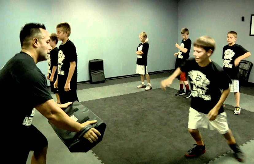 A Krav Maga expert training a group of kids