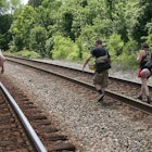A family walking train tracks