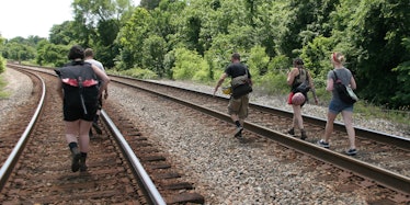 A family walking train tracks