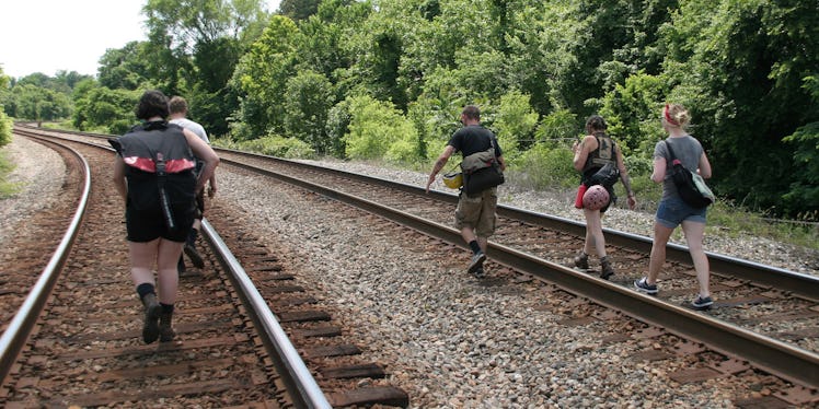 A family walking over train tracks