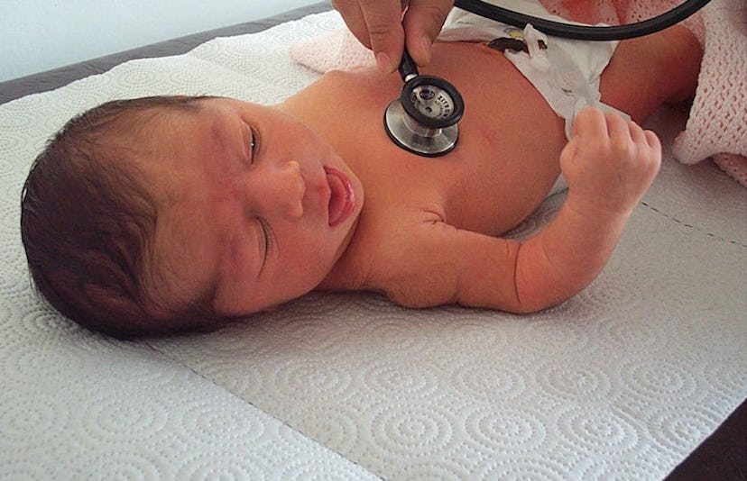 A baby getting a checkup at the doctor's office 