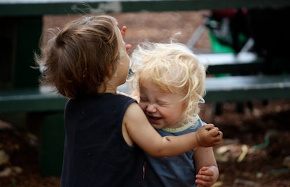 Two little kids playing in a garden