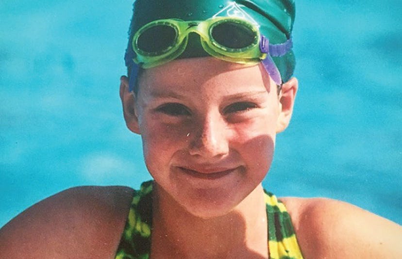 Missy Franklin posing in a pool in her swim wear when she was a kid 