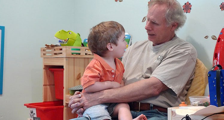 A grandfather sitting and talking to his grandson