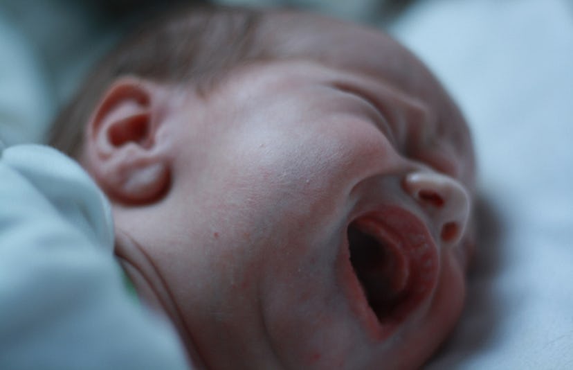 A newborn baby screaming while crying
