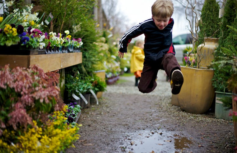 Hyperactive kid jumping over a puddle