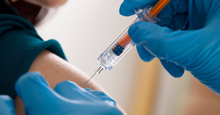 healthcare worker injects a flu shot for kids into a child's arm