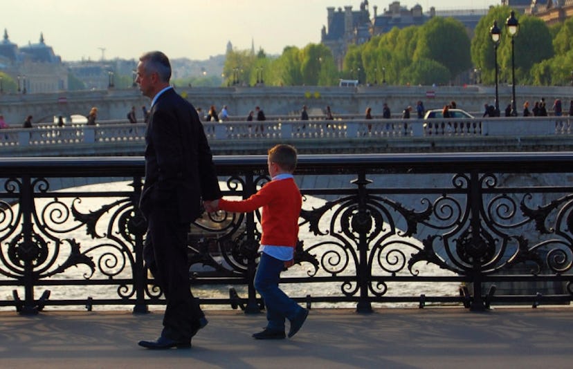 A father walking with his son over the bridge