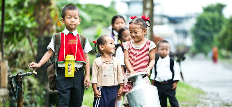 Kids In Nepal Filling A Water Jug