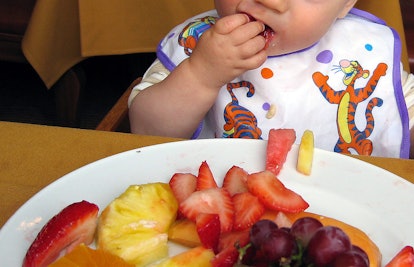 baby eating fruit plate