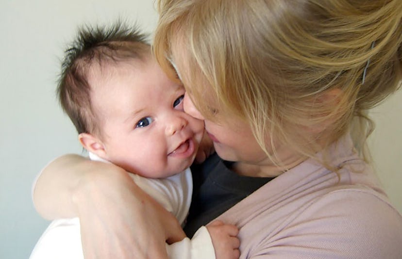 baby smiling with mother