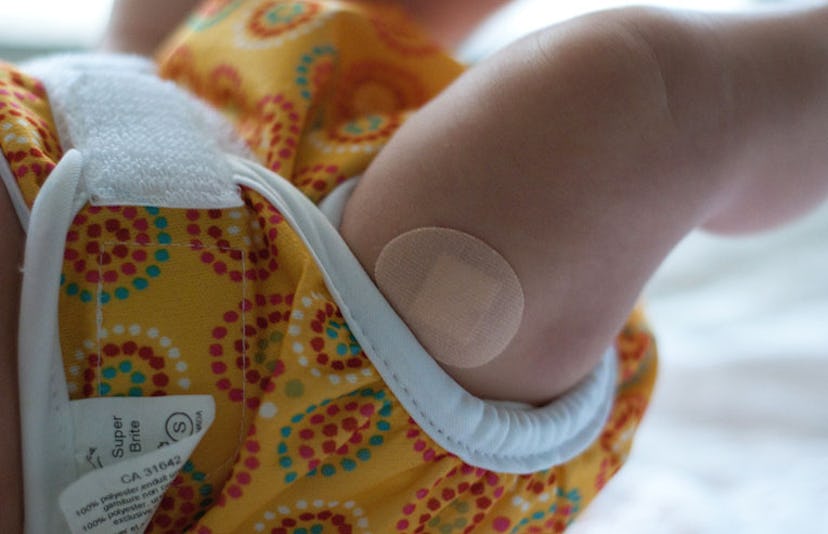 baby wearing bandaid after vaccination