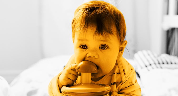 sepia edit of a baby with baby teething symptoms chewing on a teething ring