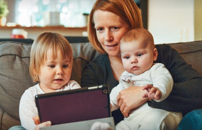babies using ipad with mother