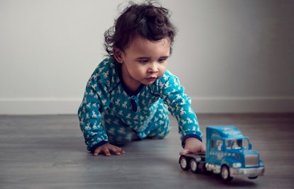 baby playing with toy truck