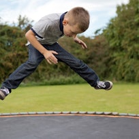 boy jumping on trampoline