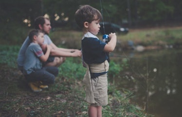 boys fishing with father