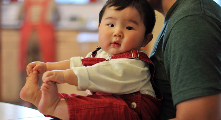 chubby baby in red overalls