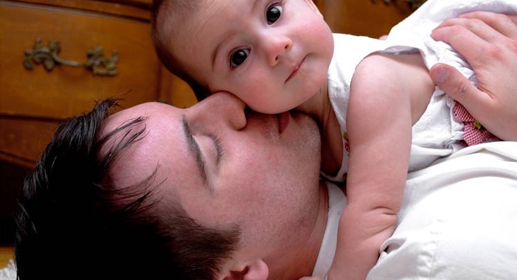 father kisses baby