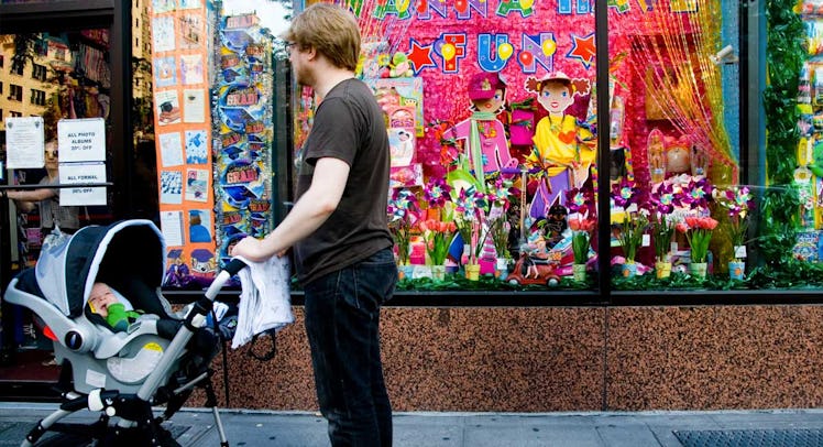 father pushing baby stroller