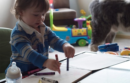 toddler drawing with crayons