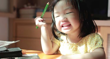 toddler holding pencil