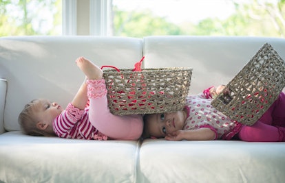twin babies playing with baskets