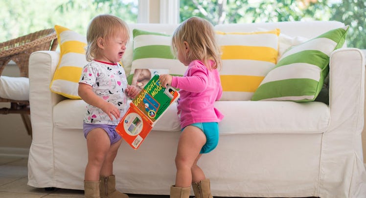 twins fighting over a book