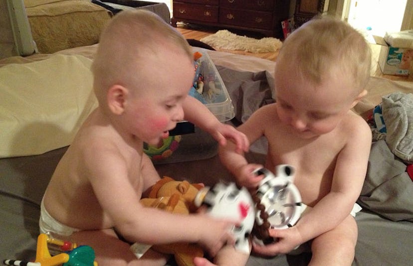 twins fighting over toy