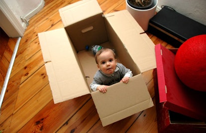 baby playing in box