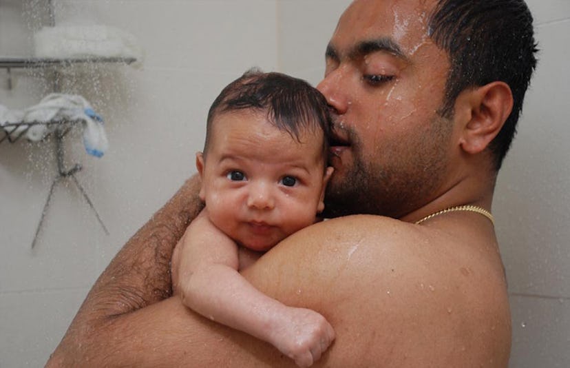 father showering with baby