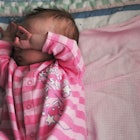 newborn baby covering eyes