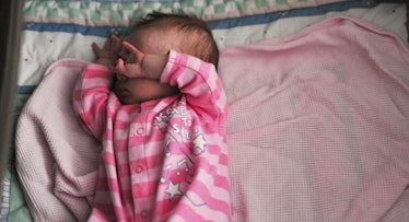 newborn baby covering eyes