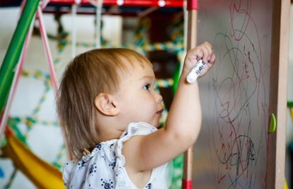 toddler drawing on whiteboard