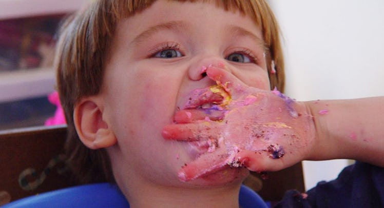 toddler eating birthday cake
