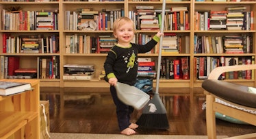 toddler sweeping floor