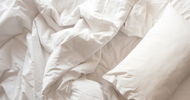 of white rumpled bed sheet