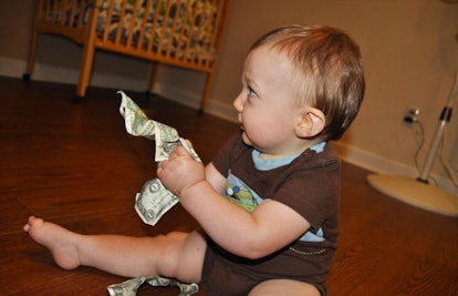 baby crumpling dollar bills