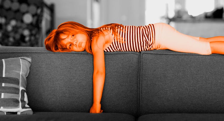 A kid bored on the couch
