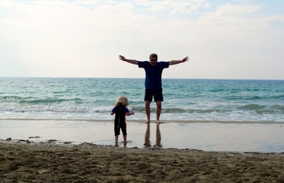 father and toddler at the beach