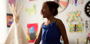 girl wearing blue dress in bright room